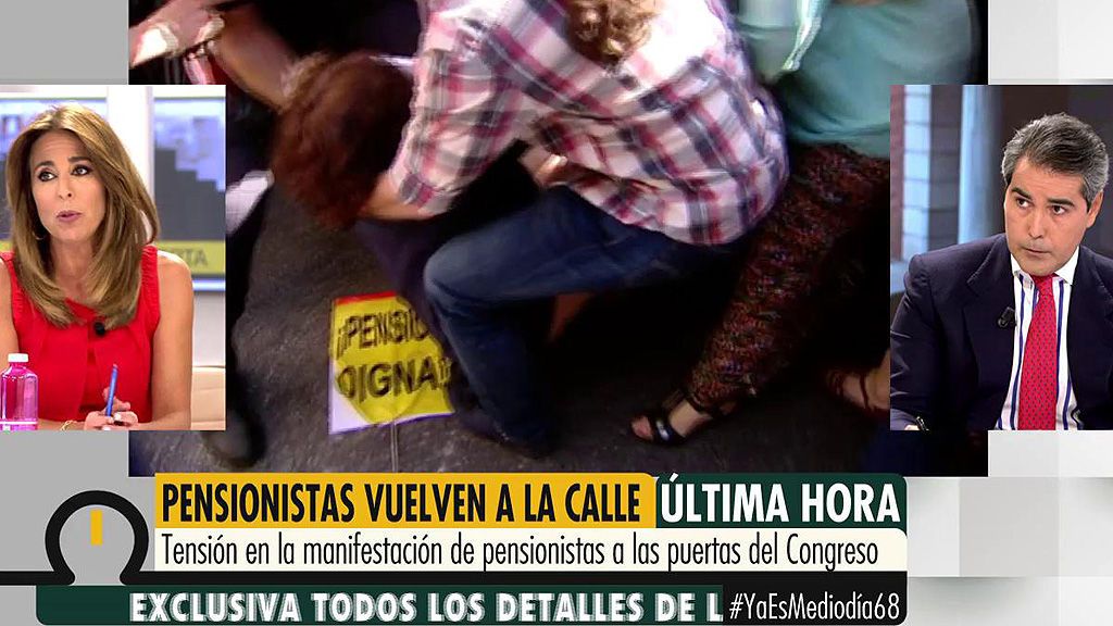 La diputada de Podemos, Gloria Elizo, cae al suelo arrollada por la gente durante la manifestación de pensionistas
