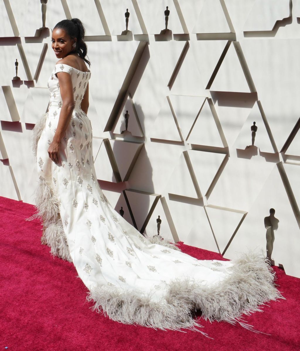 June Ambrose con una espectacular cola bordada en piedras y plumas