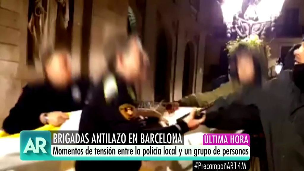 Tensión entre la policía y un grupo de personas que retira un lazo del ayuntamiento de Barcelona