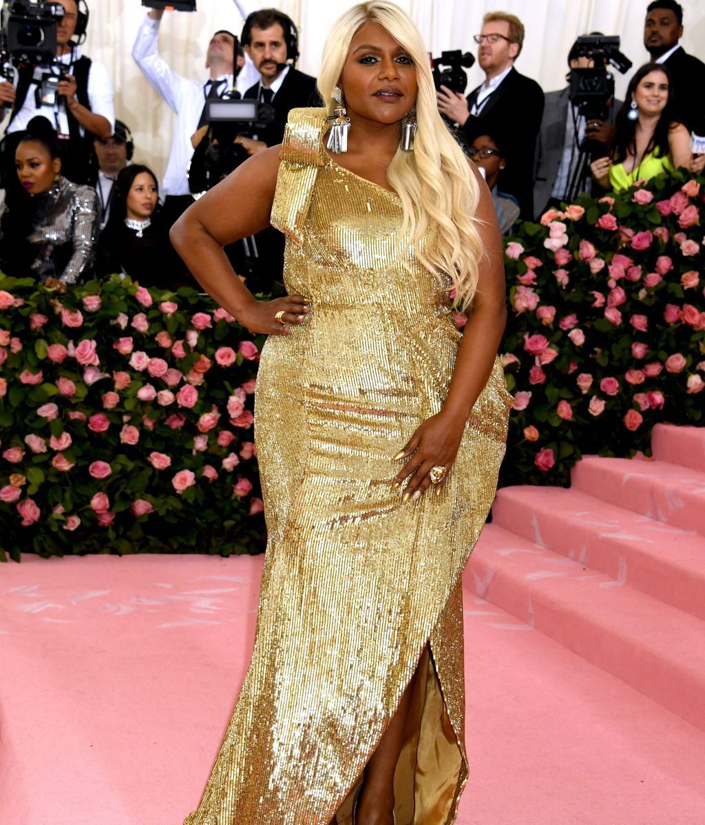 Mindy Kaling de dorado de pies a cabeza, cabello incluido, vestida por Moschino