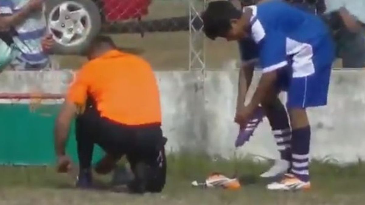 Un árbitro le da sus botas a un jugador para que pueda seguir jugando después de que se le rompieran Un árbitro le da sus botas a un jugador para que pueda seguir jugando después de que se le rompieran