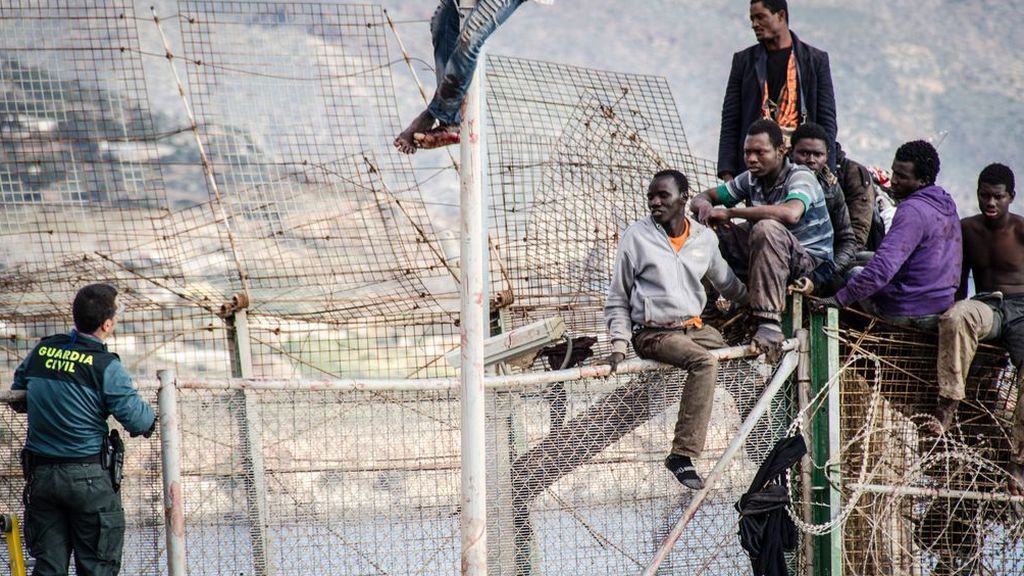 Migrantes encaramados en la valla Melilla