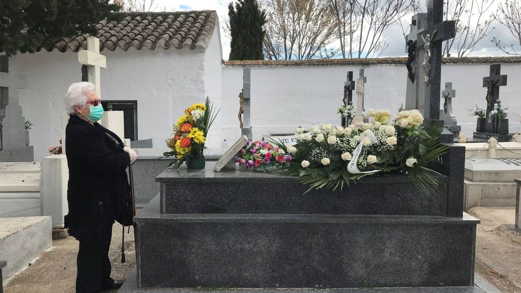 Una mujer frente a una tumba