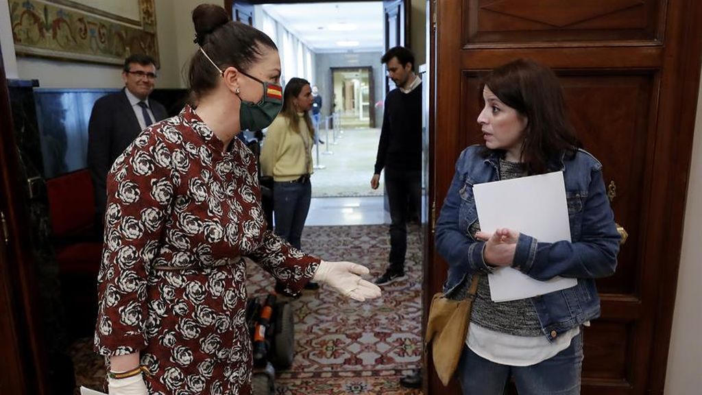 La portavoz de Vox, Macarena Olona, charla a través de su mascarilla con la socialista