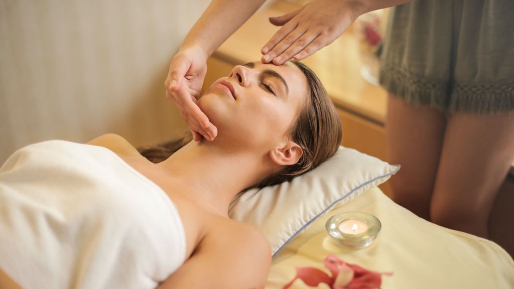 woman-in-wrapped-in-white-towel-lying-on-bed-getting-massage-3757657