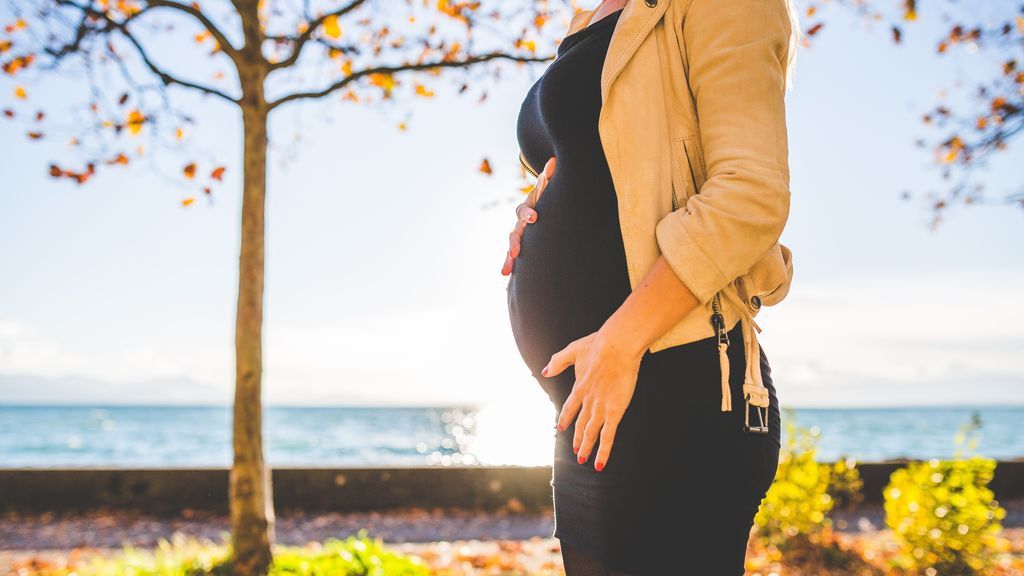 pregnant-woman-wearing-beige-long-sleeve-shirt-standing-near-132730