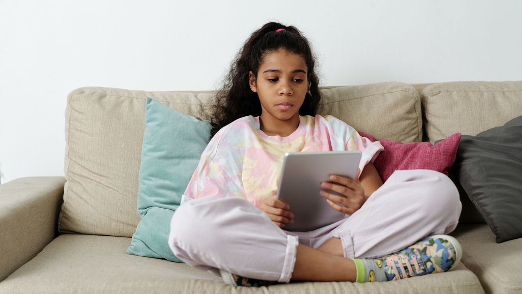 girl-in-pink-shirt-sitting-on-couch-4144042