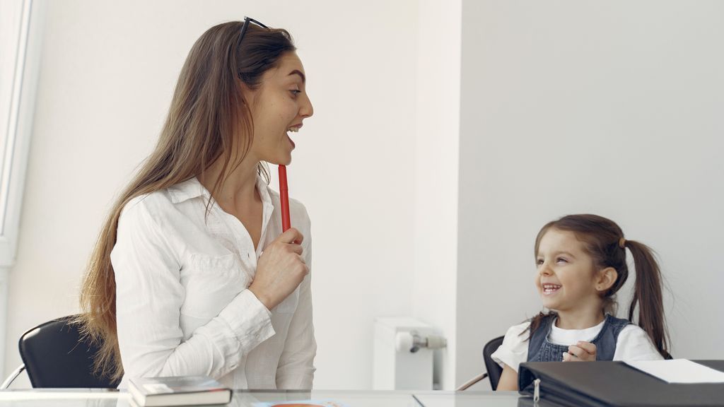 cheerful-woman-and-kid-having-fun-in-office-4149077