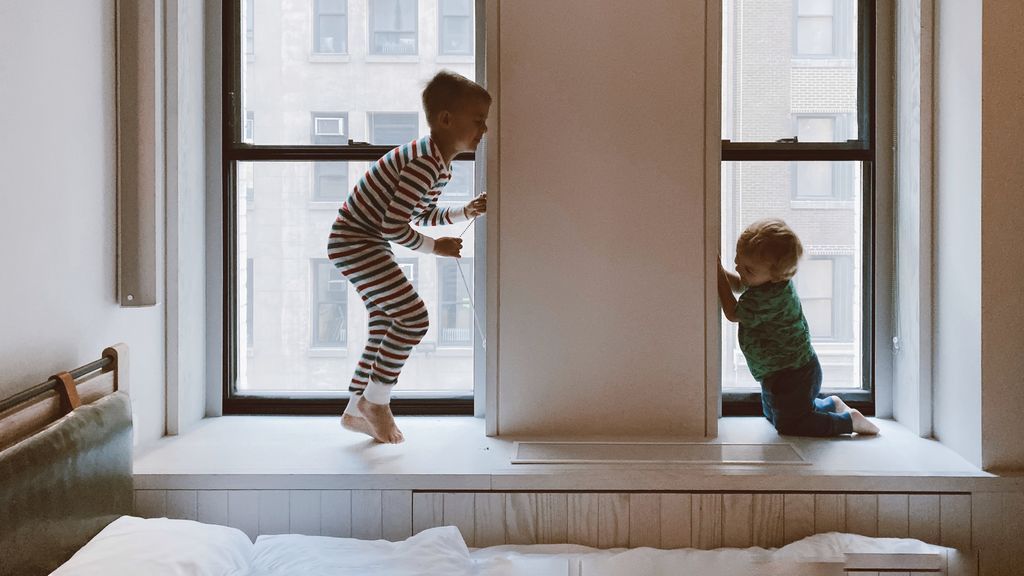 two-kids-playing-beside-glass-windows-3273851