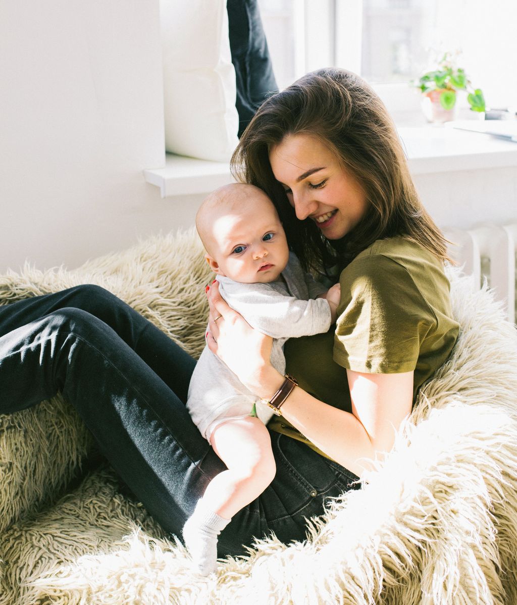 woman-in-green-shirt-holding-baby-while-sitting-698877
