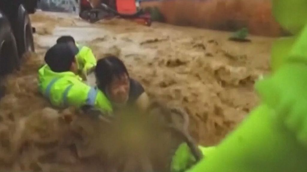 Rescate al límite tras quedar una mujer atrapada en su coche por las inundaciones en China