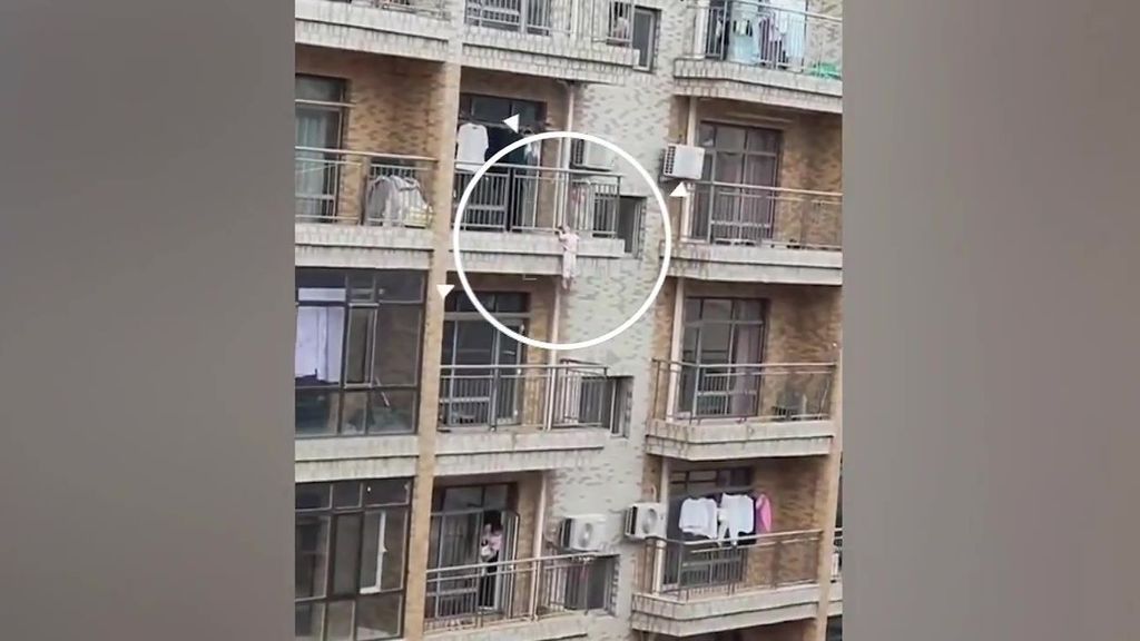 En imágenes | El angustioso rescate de una niña a punto de caer de un balcón