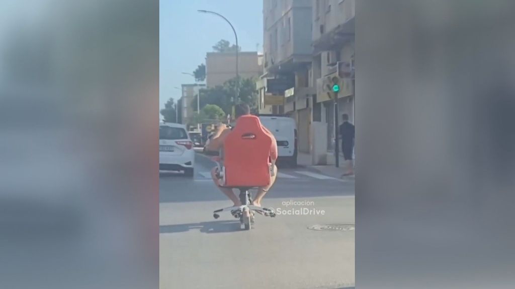 Cazado en las carreteras de Málaga: circula en patinete eléctrico sobre una silla de escritorio (Junio 2022)