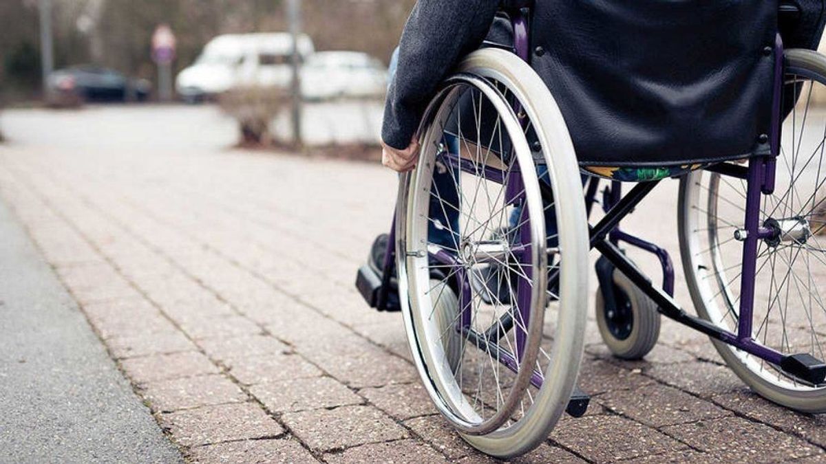 Un anciano se desplaza en silla de ruedas Un anciano se desplaza en silla de ruedas