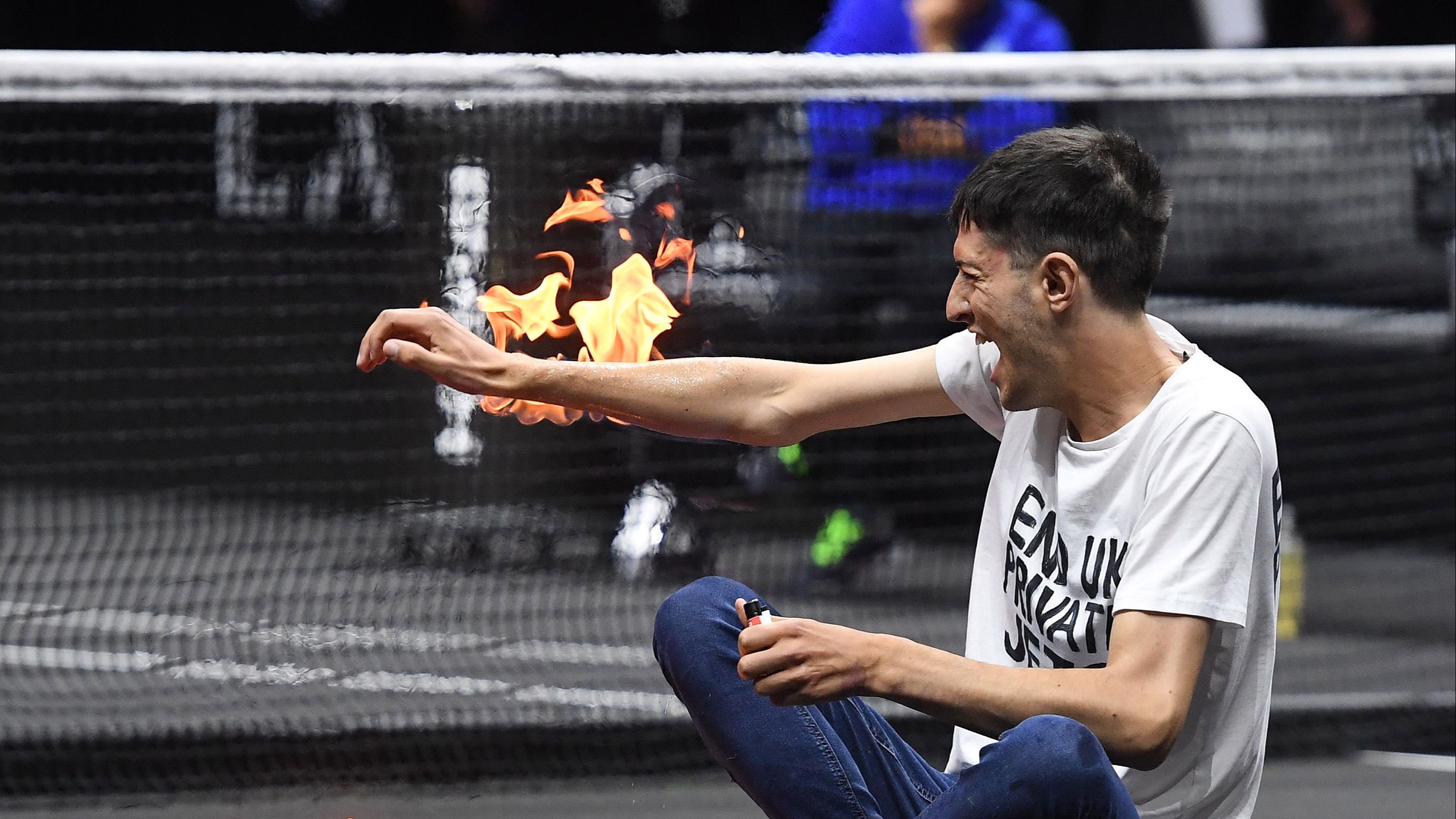 A man jumps onto the Laver Cup track and sets his arm on fire