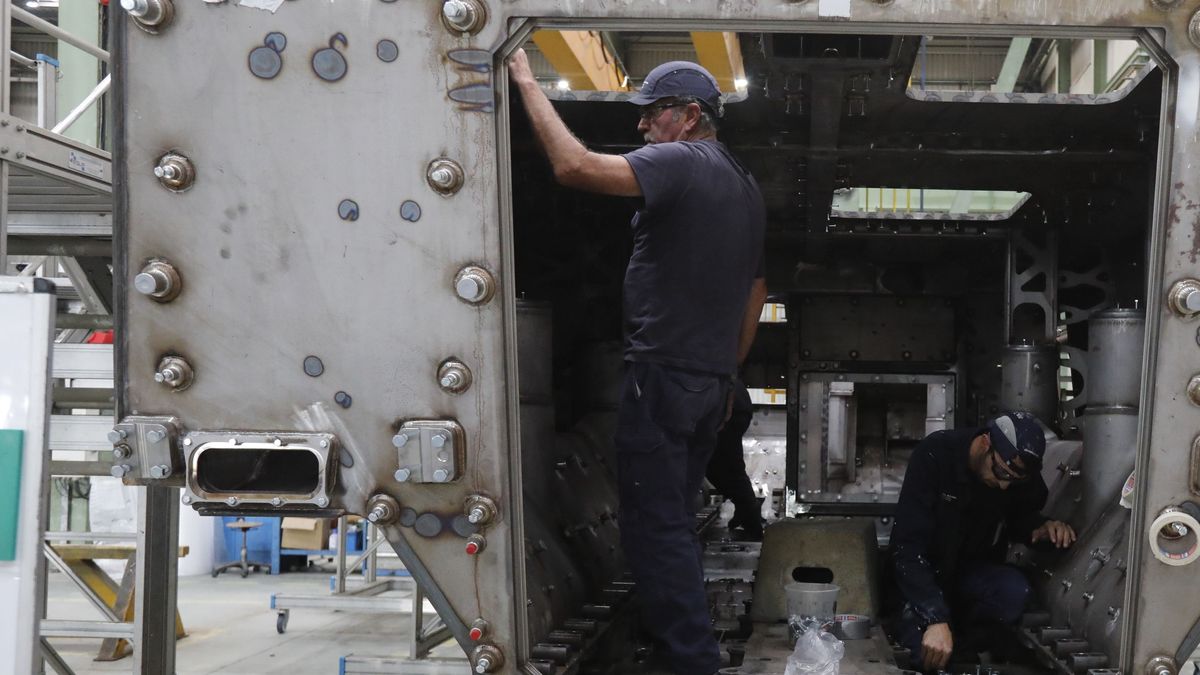 Dos operarios trabajan en una fábrica Dos operarios trabajan en una fábrica
