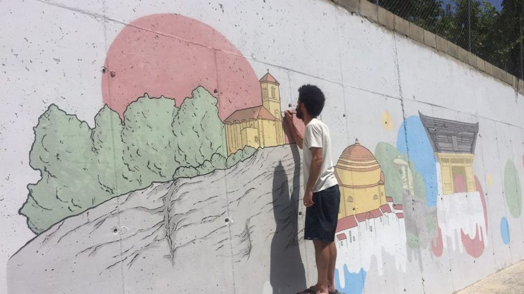 El artista Eugenio Romero pintando el mural dedicado a Japón en Montefrío