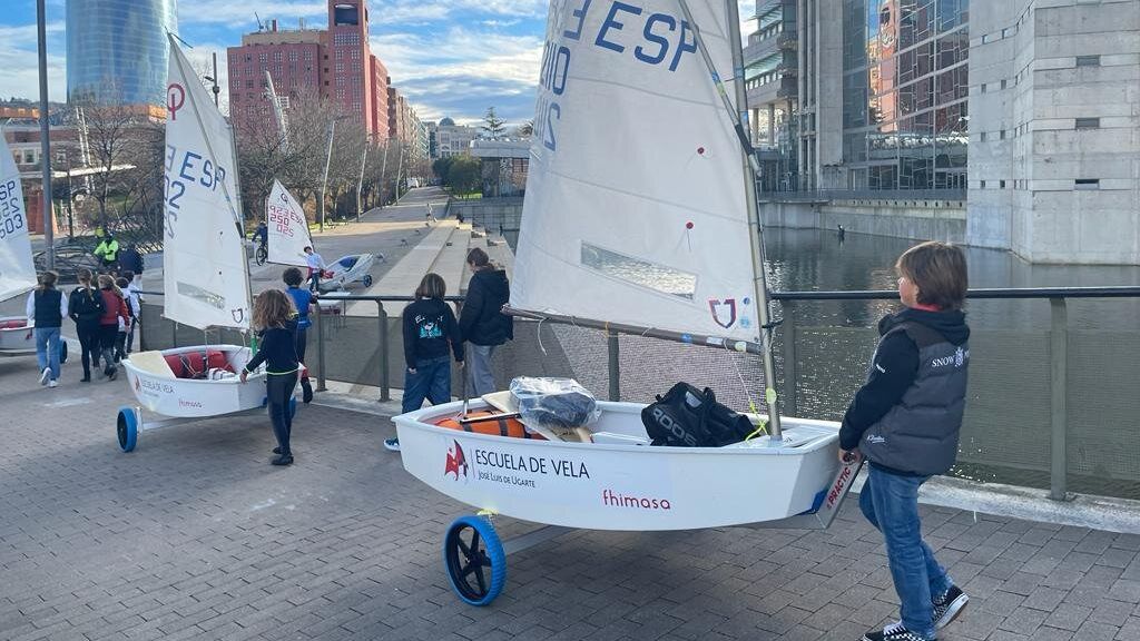 Varios chavales con las embarcaciones Optimist