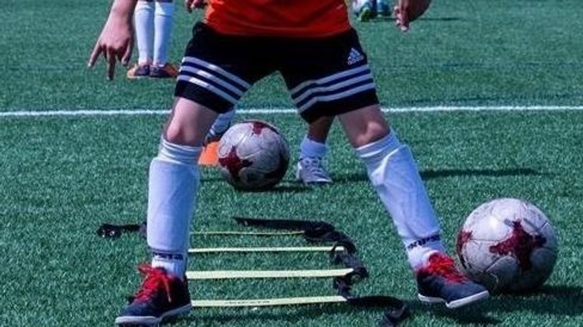 Menor jugando al fútbol Menor jugando al fútbol