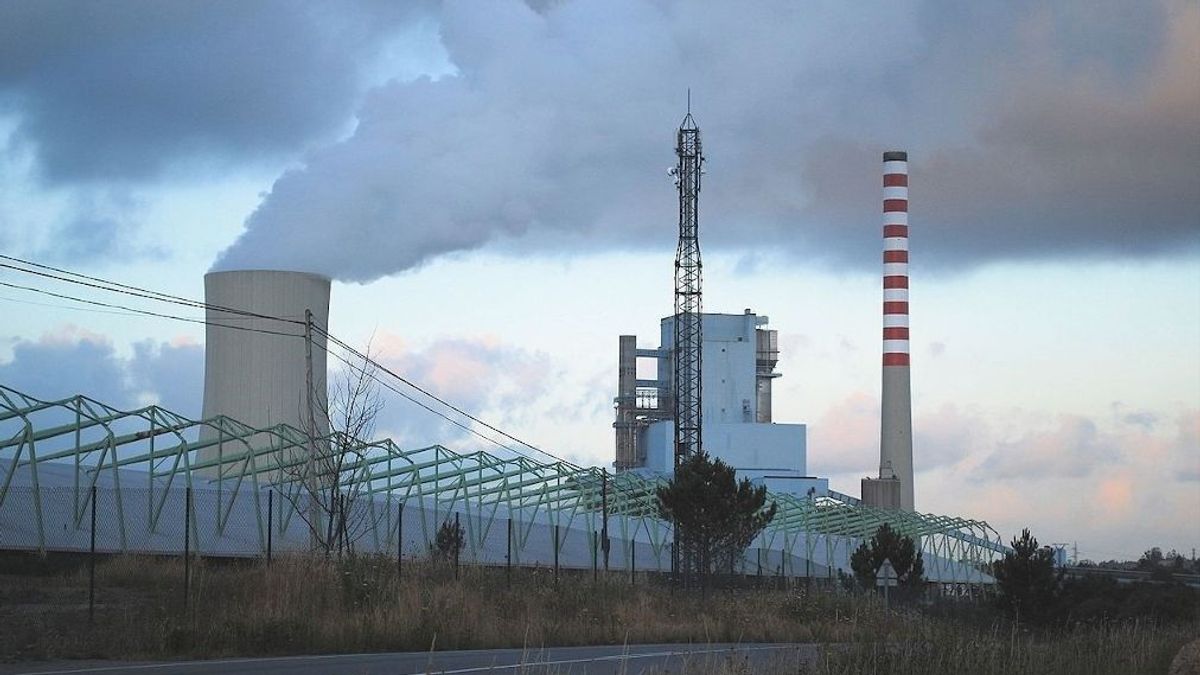 La torre de refrigeración (ya desaparecida) a la izquierda; y la chimenea que va a ser derribada, a la derecha.