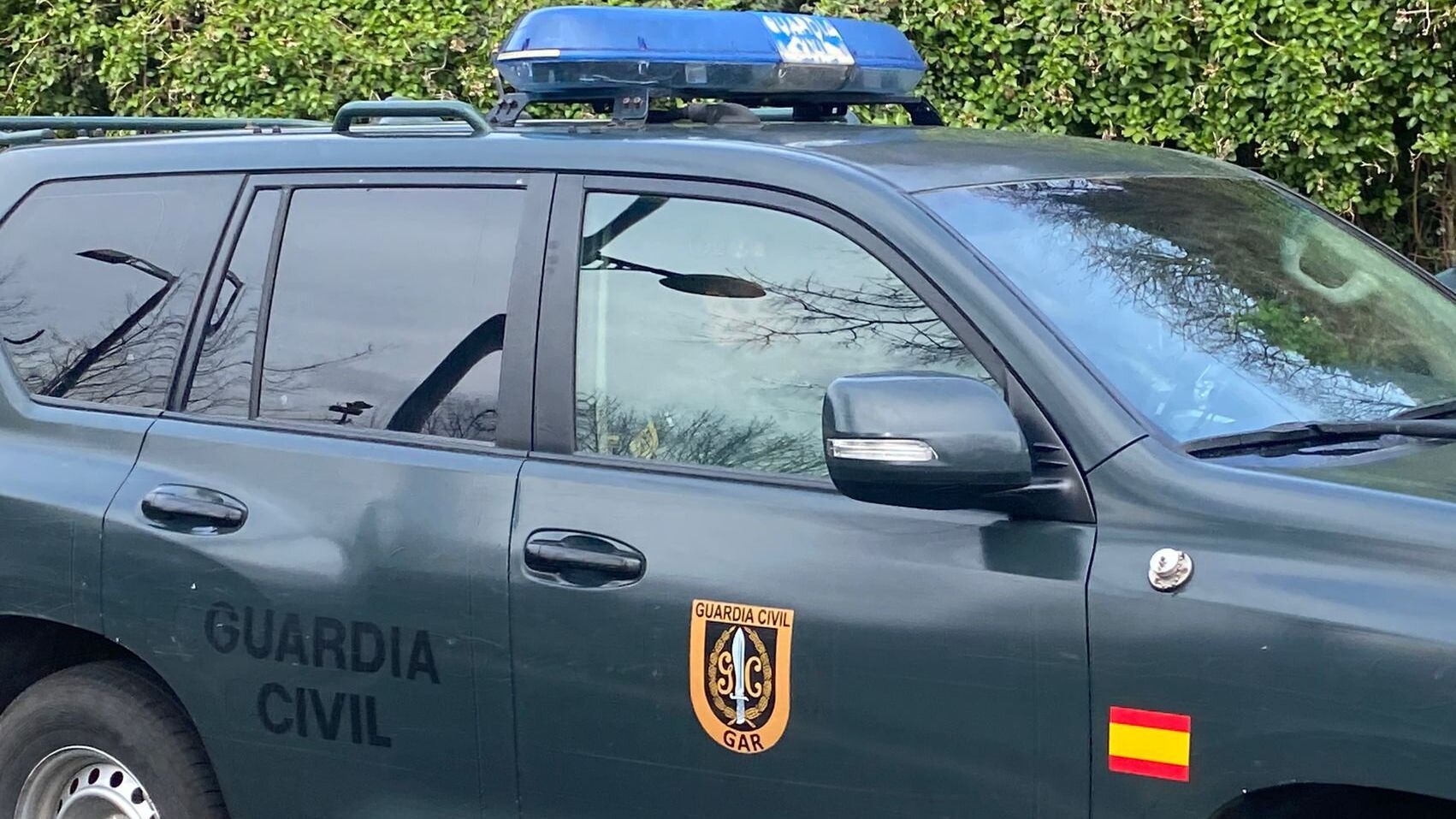 Uno de los detenidos trasladado en un coche policial