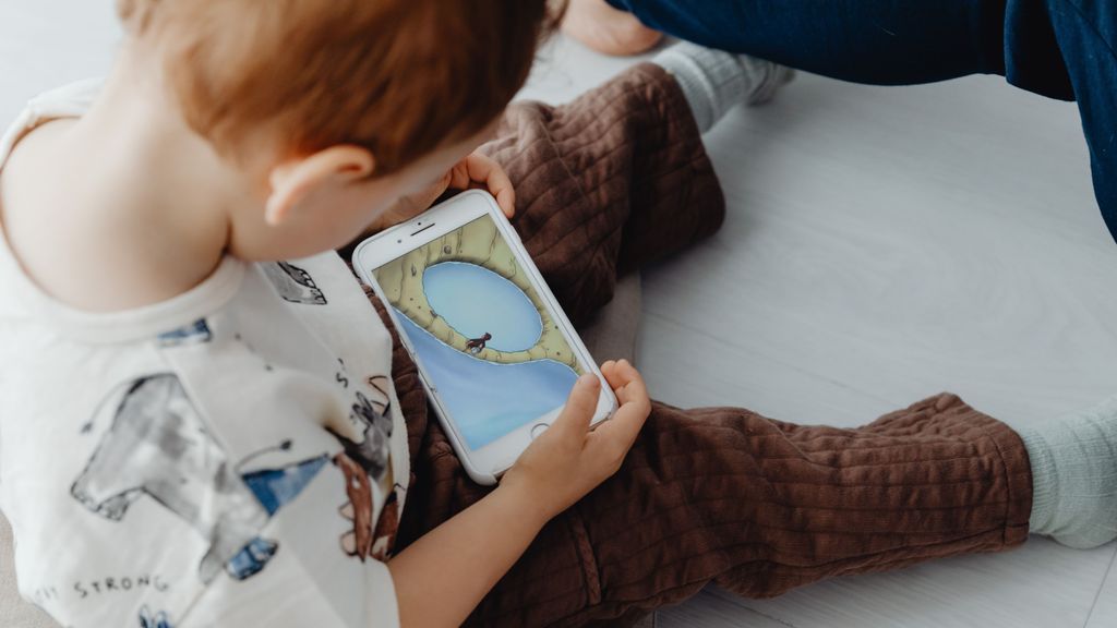 Un niño mirando un vídeo en un teléfono móvil