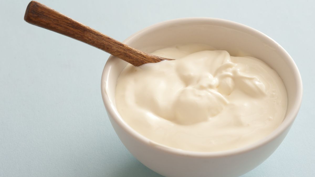 Bowl of sour cream with a spoon