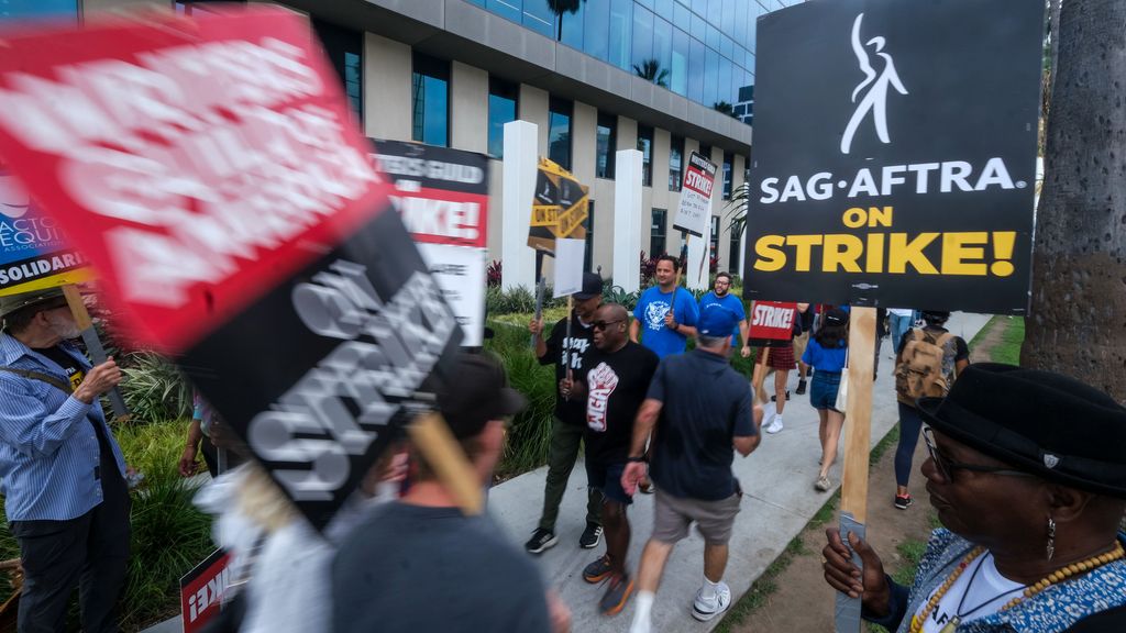 Striking writers and actors walk with placards outside Sunset Bronson studios during the demonstration. Negotiators for the striking Writers Guild of America met for a second straight day with representatives of Hollywood studios