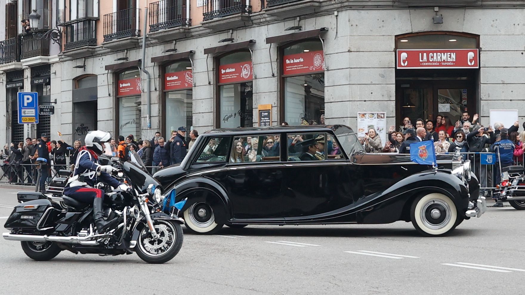 La princesa Leonor y la infanta Sofía escoltadas por la Guardia Real Motorizada saludan a los ciudadanos a su paso por la calle Mayor en su trayecto hacia el Congreso de los Diputados