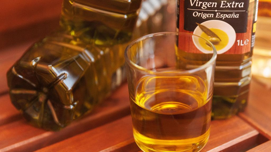 Archivo - Botellas y vasos de aceite de oliva