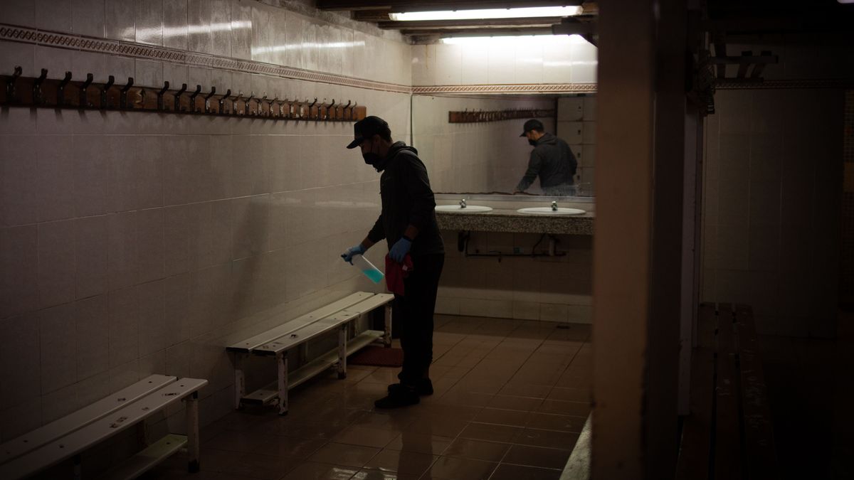Un hombre desinfecta el vestuario de un gimnasio en Barcelona