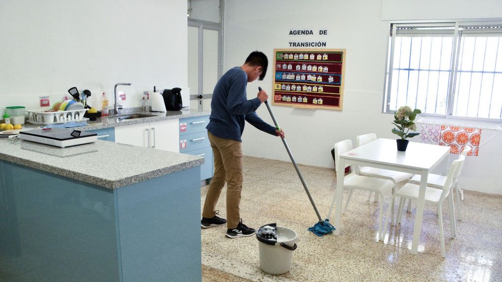 Alumno fregando el suelo en el 'aula hogar' de un colegio en Málaga