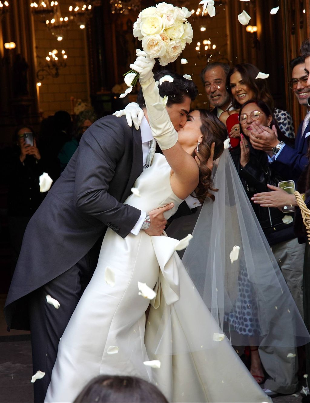 Los novios, besándose a la salida de la iglesia, ya como marido y mujer