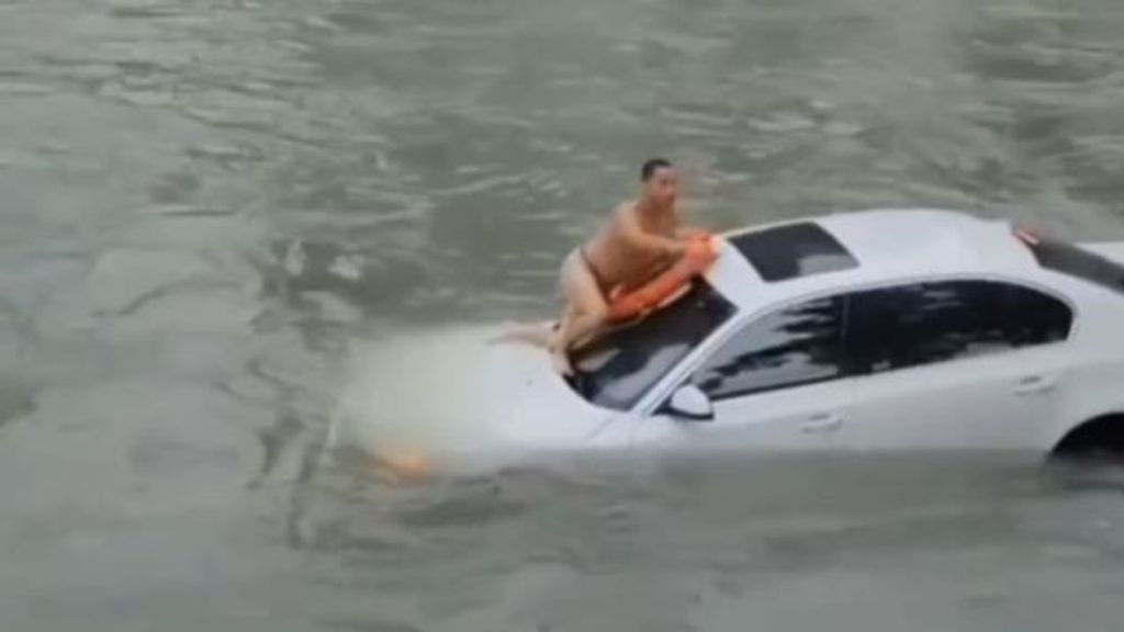 Angustioso rescate en China de un conductor atrapado en su coche tras ser arrastrado por las agua de un río crecido