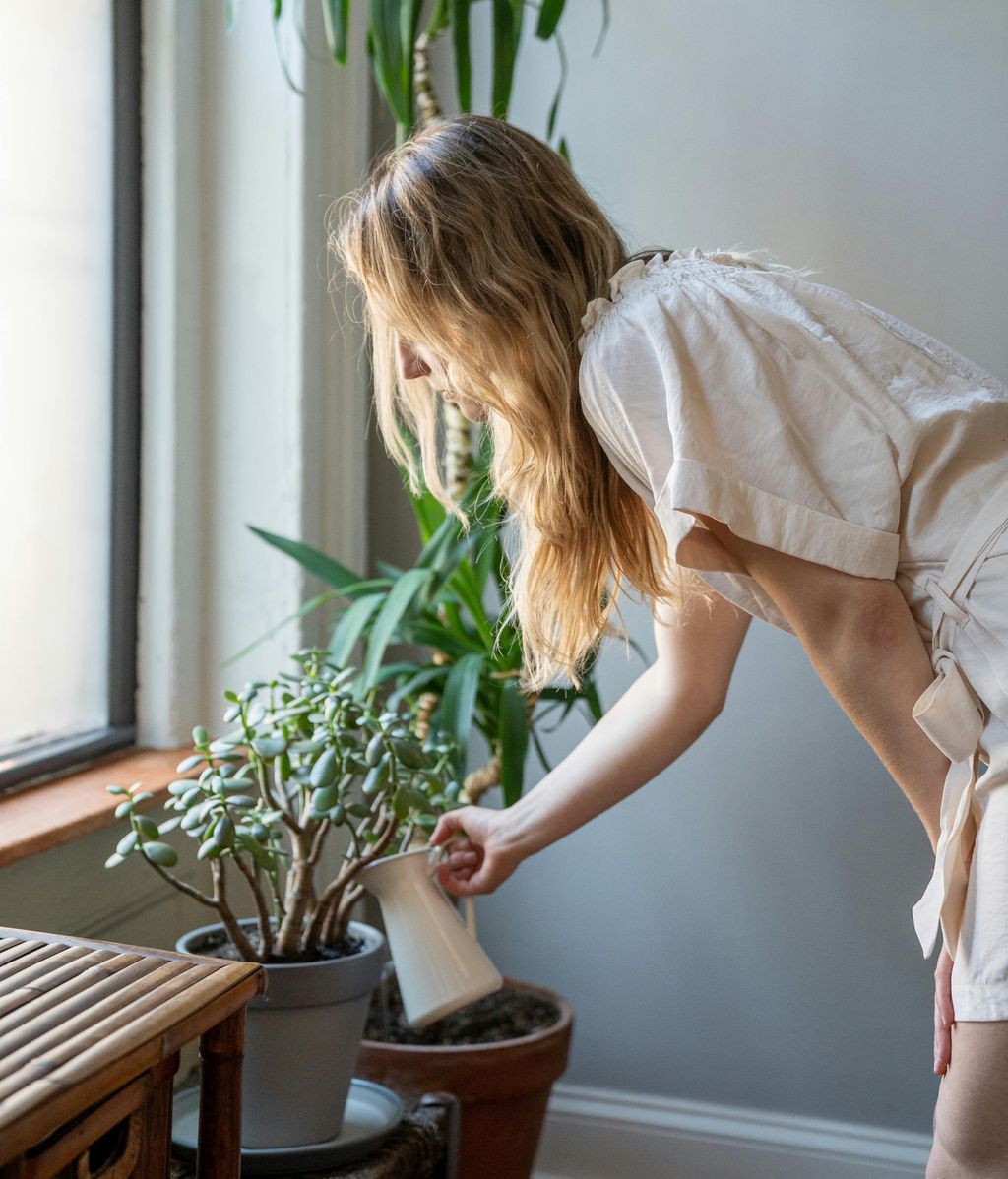 Una chica regando sus plantas