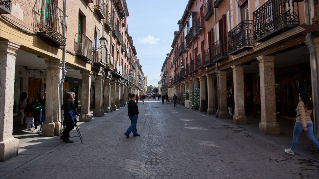 Varias personas pasean por la calle Mayor de Alcalá de Henares, Madrid