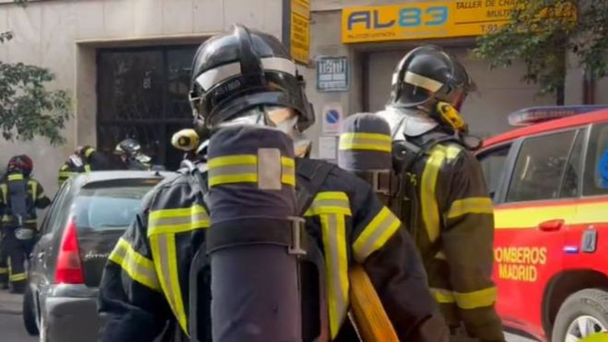 Bomberos trabajando en el desalojo del edificio de Madrid tras el incendio de un restaurante