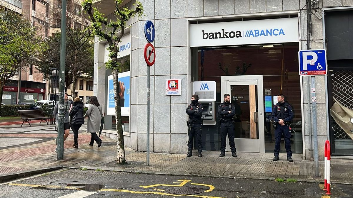 Tres agentes de la Ertzaintza ante una sucursal bancaria de Bilbao durante la investigación de un atraco, el pasado abril.