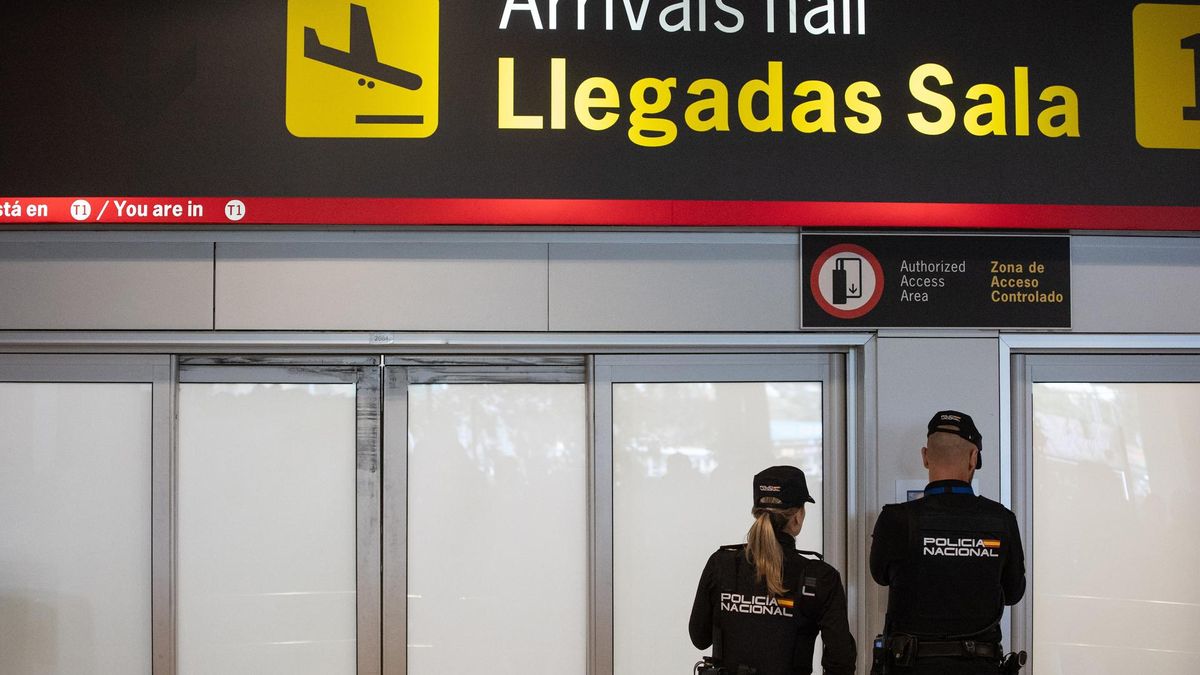 Archivo - Dos agentes de la Policía Nacional en la puerta de llegadas de la terminal T1 del Aeropuerto Adolfo Suárez Madrid Barajas