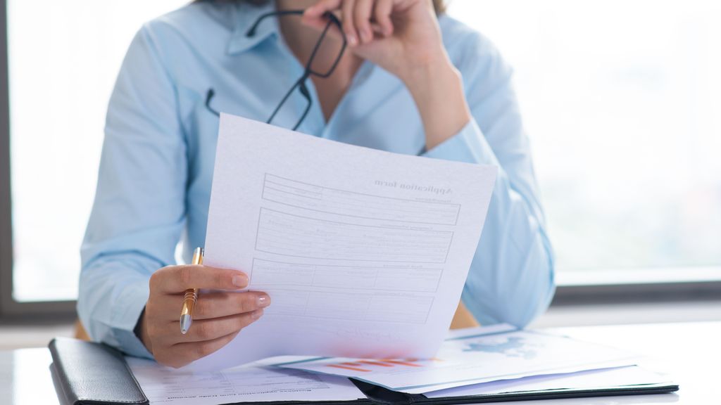 Closeup of woman holding and reading document