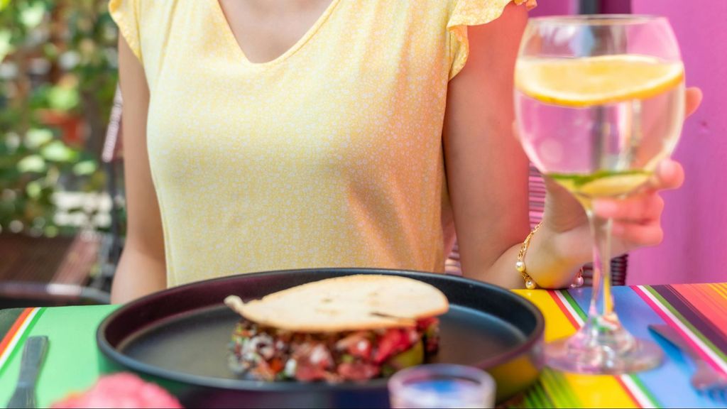 Una joven con un vaso con agua y limón