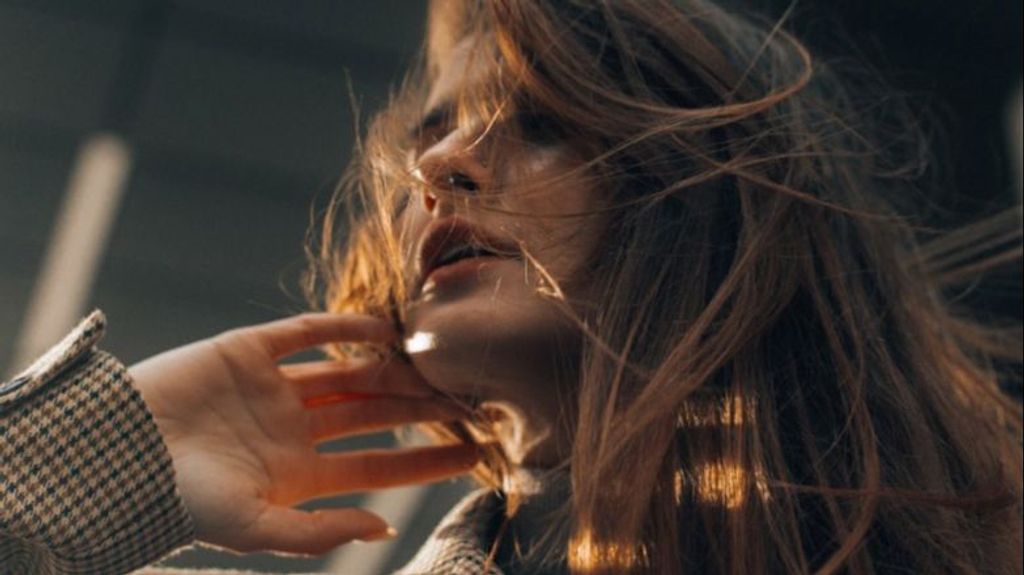 Una mujer mostrando su cabello en movimiento.