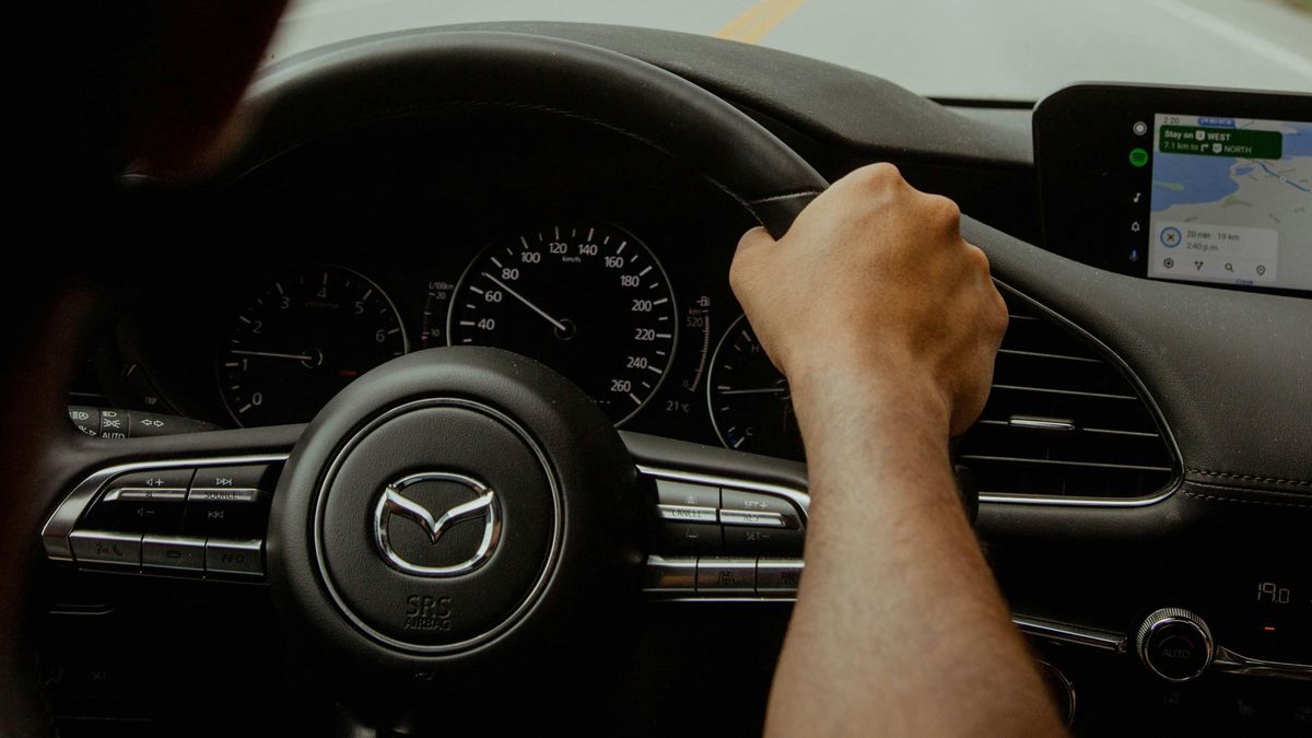 Joven conduciendo un vehículo Mazda