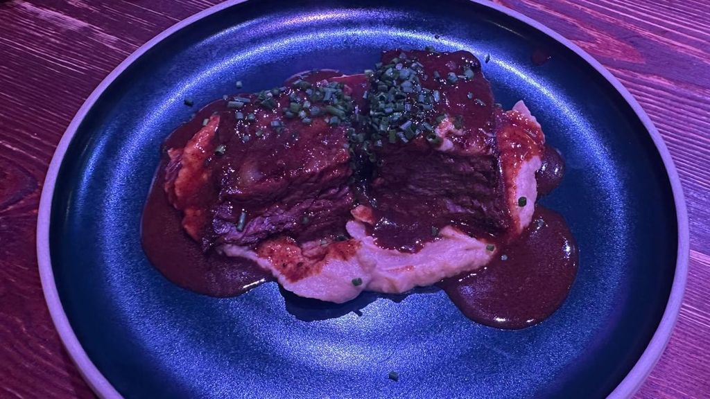 La parte salada una costilla de vaca, presentada como un anticucho peruano, cocinada durante 14 horas con puré de apionabo