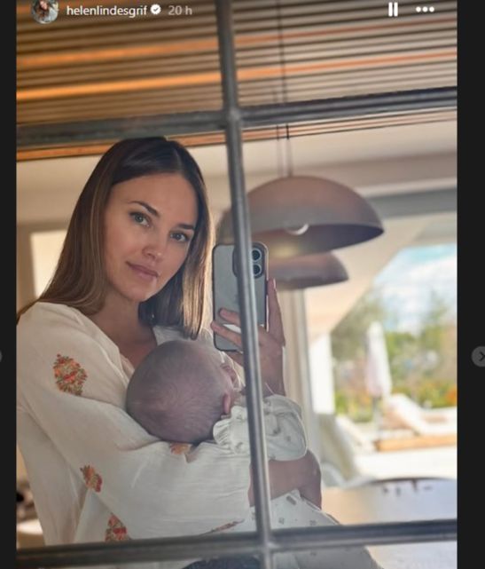 Helen Lindes posando en el espejo con su bebé