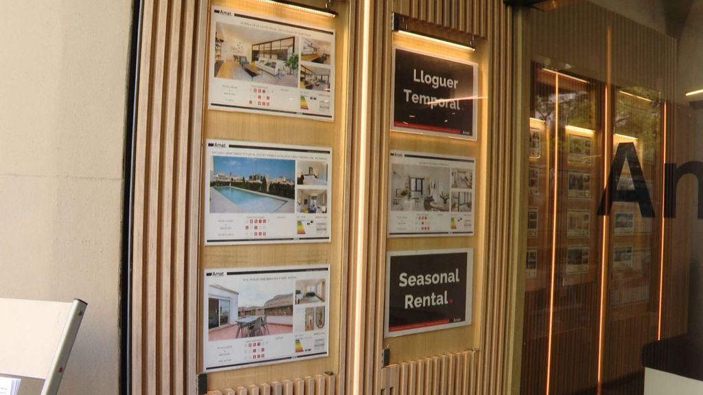 Exterior de una de las inmobiliarias con anuncios de alquileres temporales en Barcelona