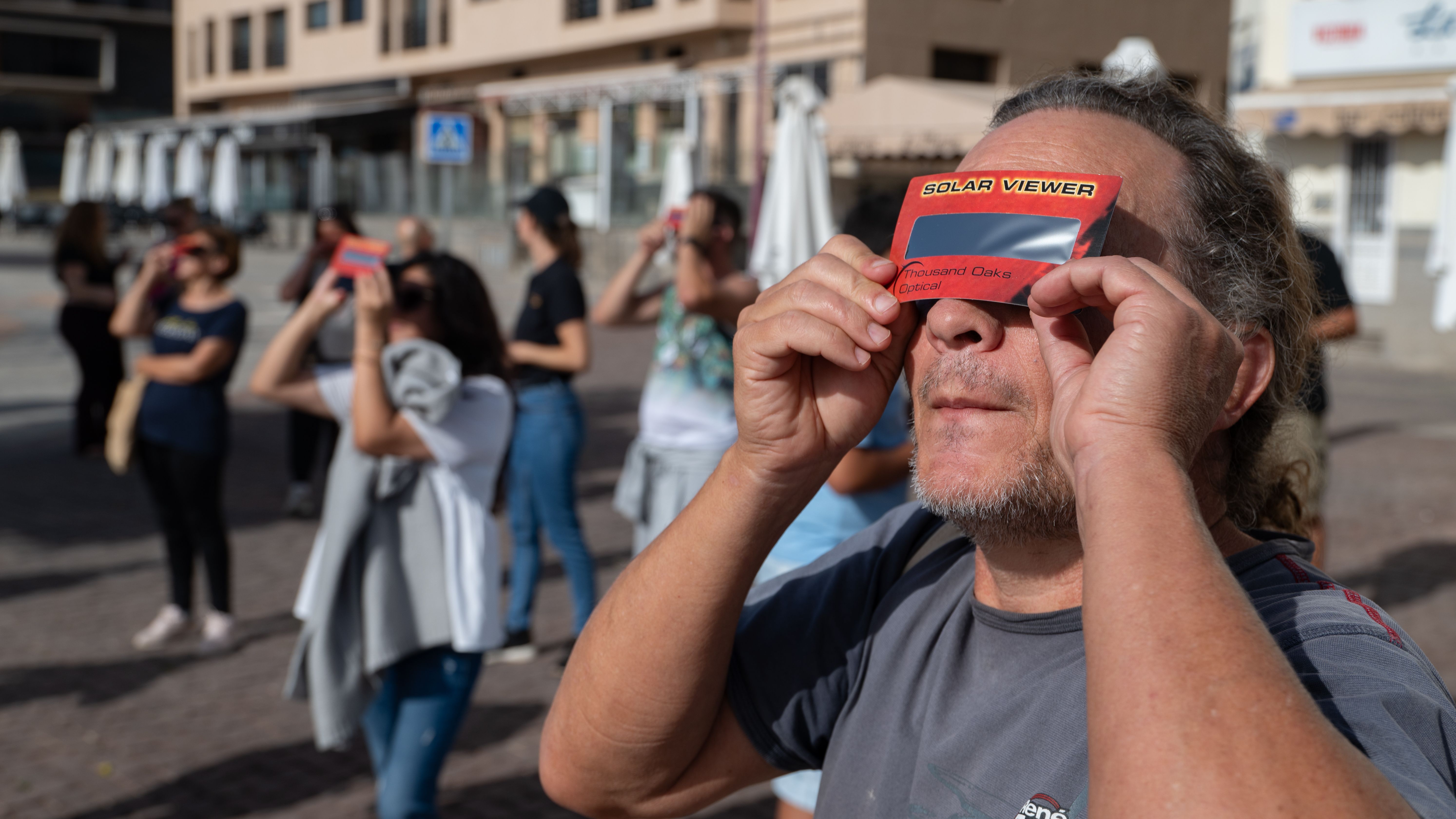 Varias personas observan el eclipse de sol desde Puerto del Rosario, Fuerteventura