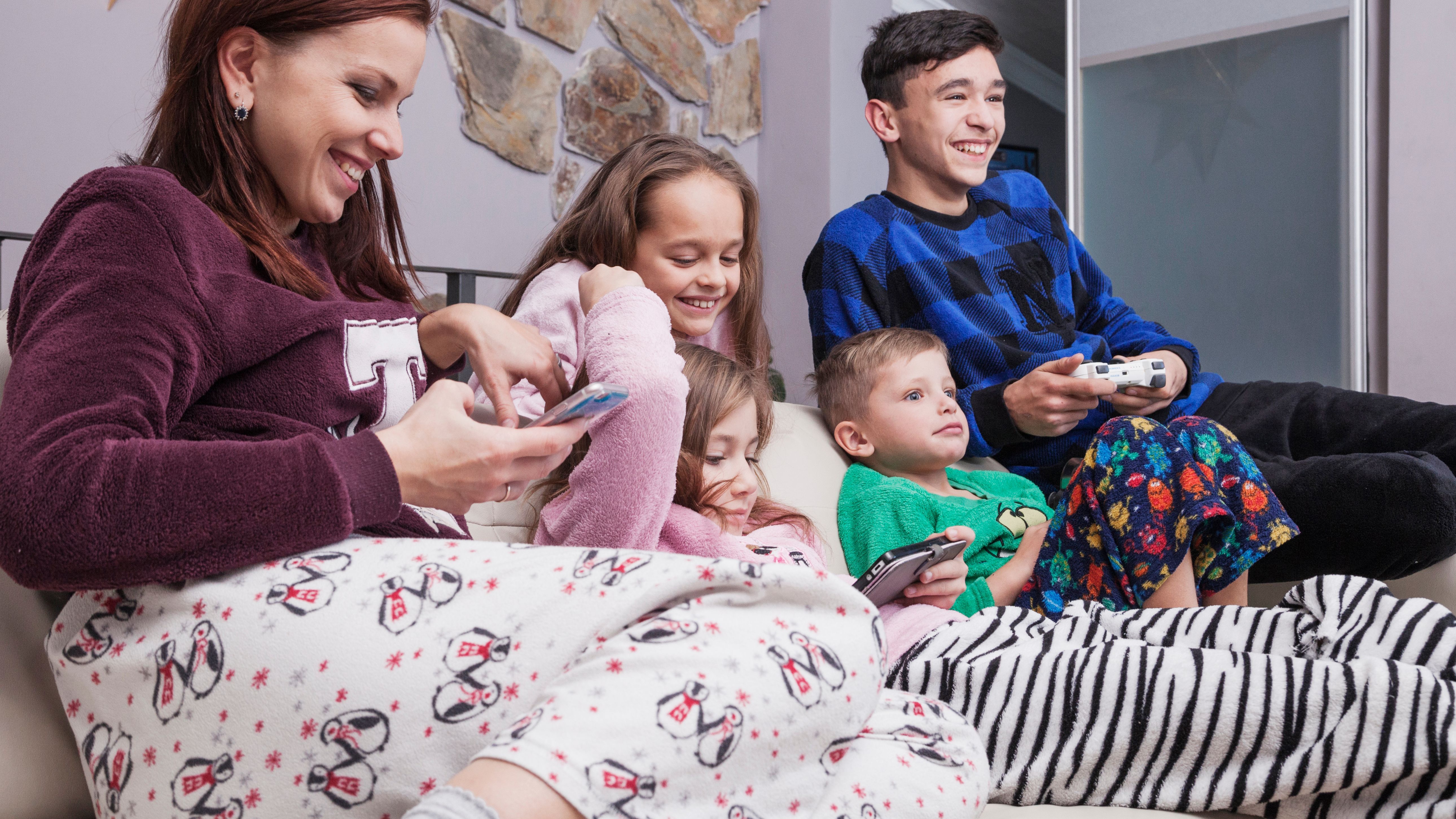 happy family using technologies sofa