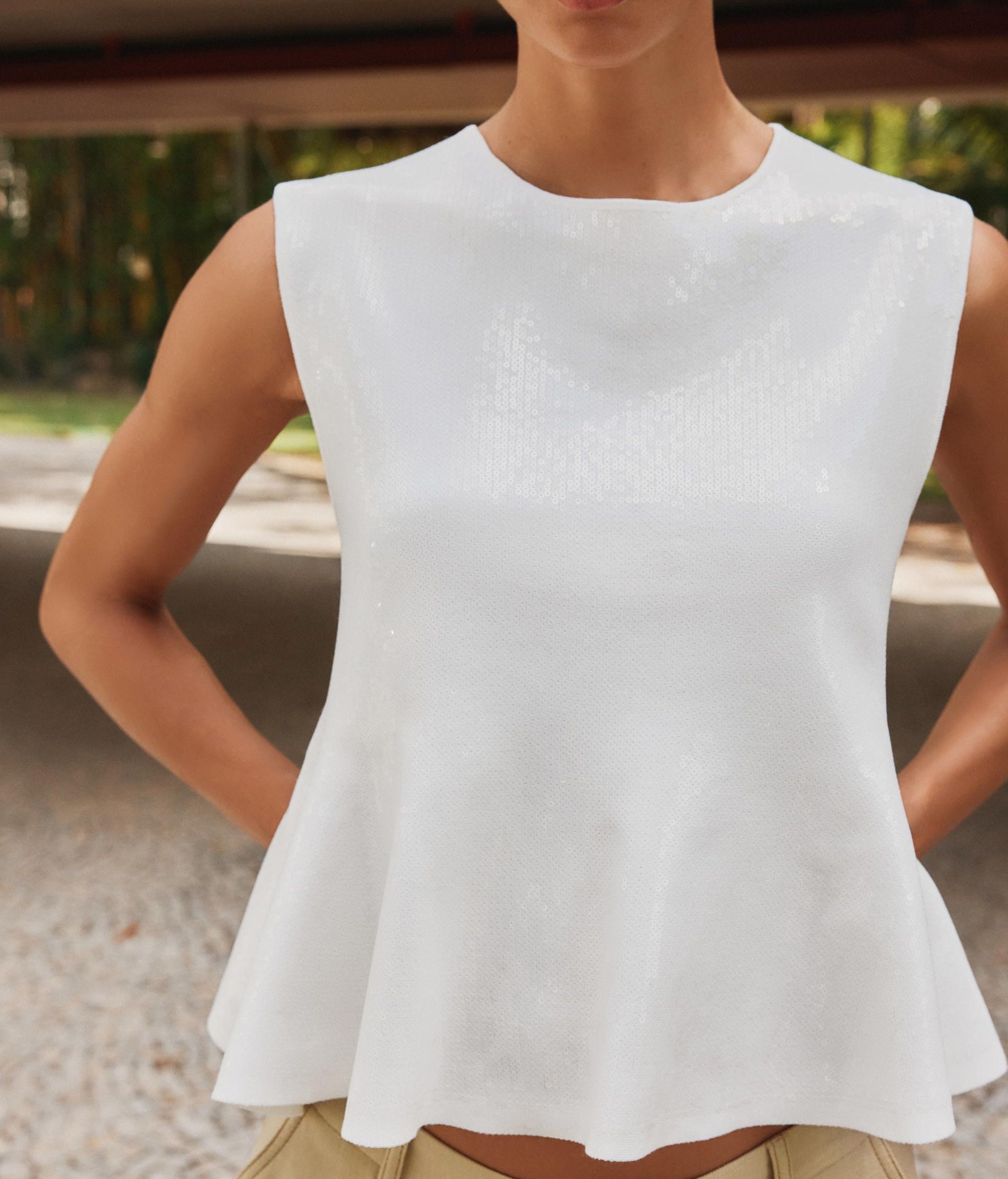 Top péplum blanco y con lentejuelas