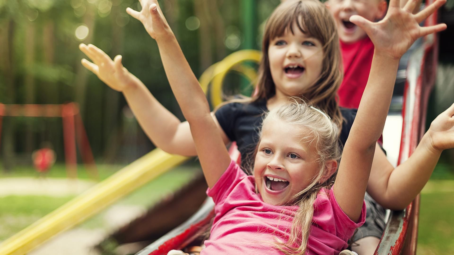 Happy kids playing on slide